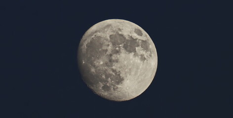 Close up picture of full moon in dark blue sky	