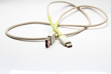USB cable type C tangled over white isolated background