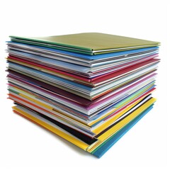 A stack of books with a variety of colors and sizes