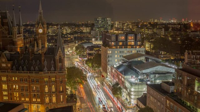 Nighttime time-lapse shot of Kings Cross area with city lights and traffic flow in London, UK