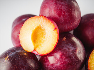 Isolated Summer Plums: Fresh and Juicy Red and Black Plums on a White Background