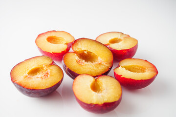 Isolated Summer Plums: Fresh and Juicy Red and Black Plums on a White Background