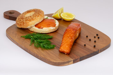 Delicious Savoury Salmon Bagel Featuring Fresh Dill and Accompanied by Zesty Lemon Wedges