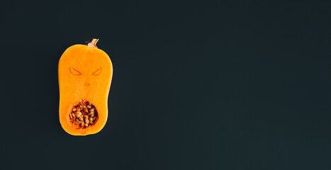 Butternut squash carved with spooky face, showcasing creative Halloween decoration ideas