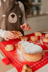 Closeup of hands prepares a festive cupcake. Happy moments with relatives on the eve of Christmas. Concept of gifts for New Year, Mother's Day and Father's Day.  Part of a series