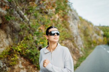 Young caucasian woman running or jogging on the country road	