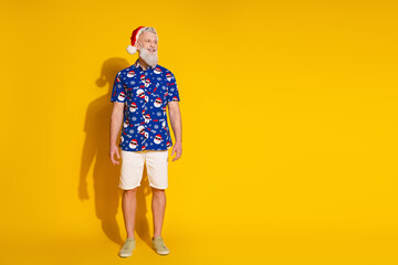 Full body portrait of stylish santa look empty space new year xmas print shirt isolated on yellow color background