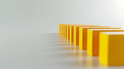 Obraz premium A line of yellow 3D blocks of the same size arranged in a row on a white surface