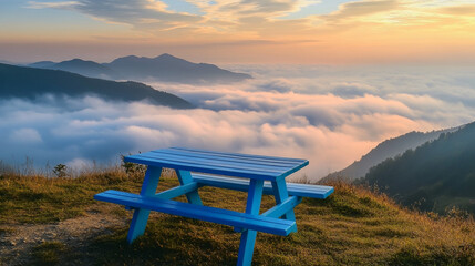 Blue Picnic Table on Mountaintop with Fog and Sunset