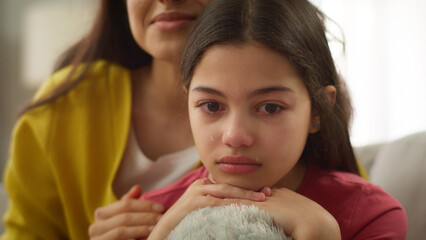 Close up Caucasian crying sad anxious depressed little girl child kid daughter cry upset by school...