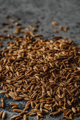 Closeup of Aromatic Cumin Seeds and Spices on a Rustic Background