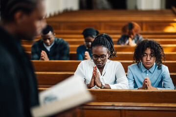 Congregation praying in church during sermon