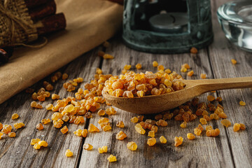 Natural Aromatic Frankincense and Myrrh Resin with Wooden Spoon on Rustic Table