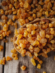Natural Aromatic Frankincense and Myrrh Resin with Wooden Spoon on Rustic Table