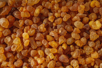 Natural Aromatic Frankincense and Myrrh Resin with Wooden Spoon on Rustic Table