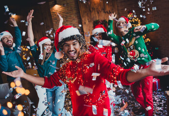 Photo of attractive young people confetti dancing disco have fun new year decoration interior home party apartment © deagreez