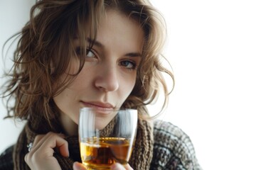 Woman covering face with wine glass