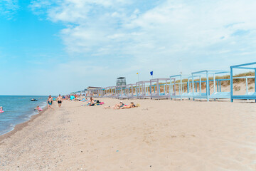 Beautiful beach in Yantarny with blue wooden sun beds and blue sky, Baltic Sea. Yantarny, Kaliningrad Oblast , Russia - 23 June 2024