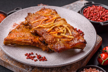 Pork or beef ribs with salt, spices and herbs baked on the grill