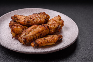 Grilled chicken wings with salt, spices and herbs