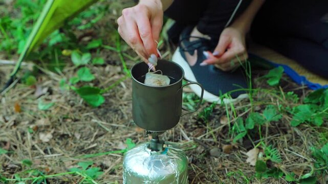 Cooking food and drinks in the forest at a campsite