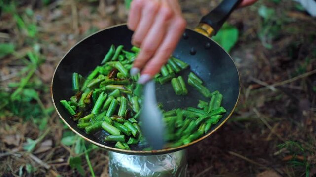 Cooking food and drinks in the forest at a campsite