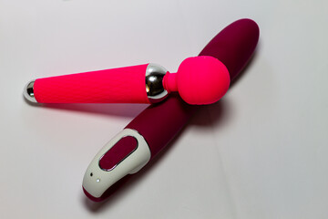 Two erotic Seh Toys of different shapes, pink and cherry color isolated on white background.