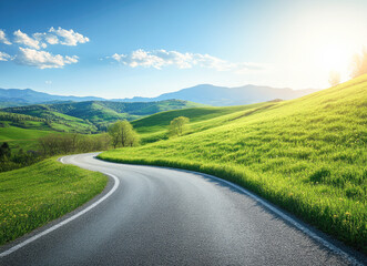 Naklejka premium Serene curving road through lush green hills under a clear blue sky