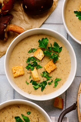 Cream of forest mushroom soup with croutons in a bowl. top veiw