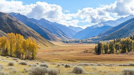 View of a beautiful valley landscape in autumn colours with mountains in background 