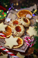 Thumbprint apricot jam and nuts Christmas cookies on holiday background