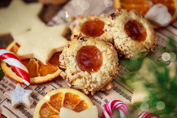 Thumbprint apricot jam and nuts Christmas cookies on holiday background