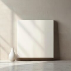 Minimalist interior canvas mockup with a blank canvas against a neutral wall. Perfect for displaying artwork or posters in a modern, clean space