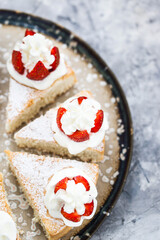 Pieces of White Angel cake, decorated with whipped cream and fresh strawberries