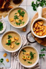Cream of forest mushroom soup with croutons in a bowl. top veiw