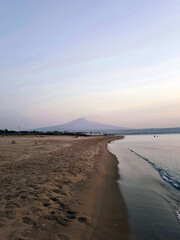 Beach and Etna volcano in Catania, Sicily.. Nature and travel in Italy 