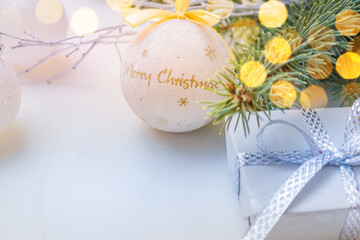 Christmas frame with balls, gift box and pine branches on a white background