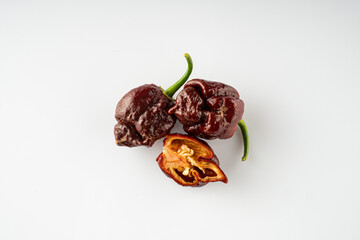 Variety of Spicy Peppers Including Aji Limo, Habanero, and Carolina Reaper on a Vibrant Background