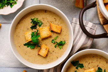 Cream of forest mushroom soup with croutons in a bowl. top veiw