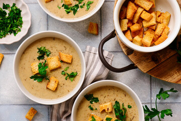 Cream of forest mushroom soup with croutons in a bowl. top veiw