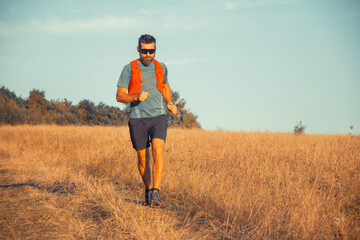 A man Runner of Trail and athlete's feet wearing sports shoes for trail running