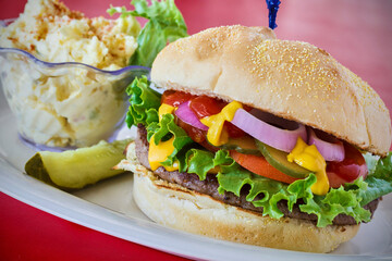 classic hamburger with lettuce, tomato, and onion
