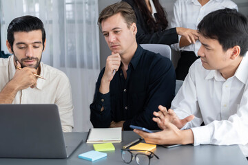 Group of diverse office worker employee take note and brainstorming on strategic business marketing planning with sticky note in office workspace. Positive and productive teamwork in workplace.Prudent