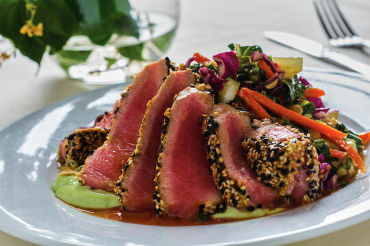 Pan seared sesame tuna over a mixed green salad