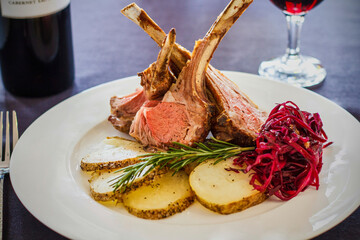 roasted rack of lamb with potatoes and braised cabbage