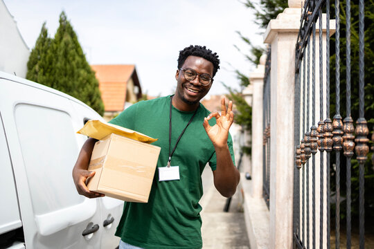 Professional deliveryman holding package supporting fast delivery.