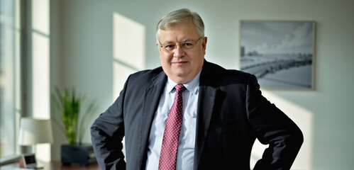 very pleased business man in their 60s, breathable modern attire, legal advisor, natural sunlight, tasteful and effective