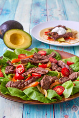 venison fajita salad with fresh tomato and green lettuce
