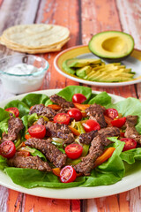 venison fajita salad with tomatoes and mixed greens