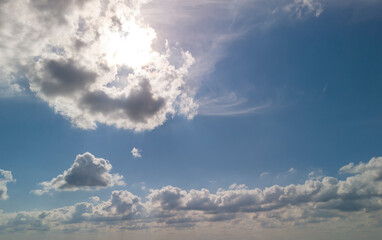 Beautiful view of a bright blue sky filled with fluffy clouds, ideal for backgrounds and designs.